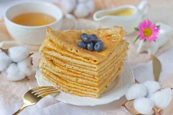 stack pancakes with blueberries background cup tea - Блины
