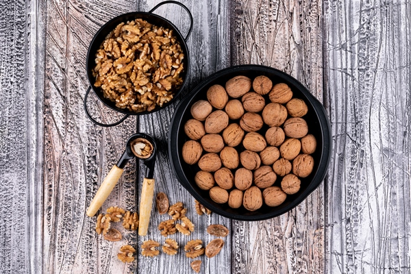 top view walnuts basket nutcracker wooden table horizontal - Орехи вместо панировки