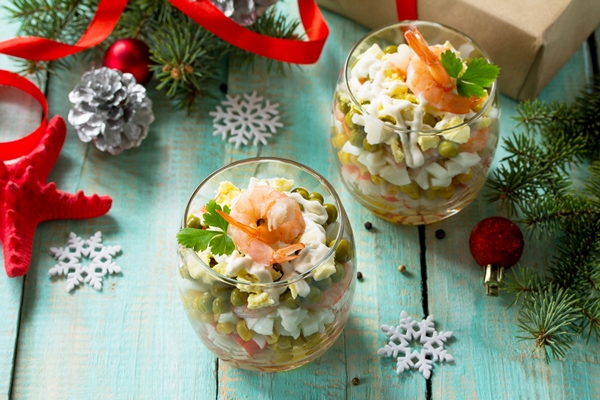 homemade snacks festive christmas table salad with shrimps crab sticks egg corn - "Оливье" с креветками
