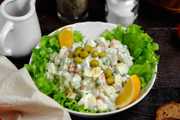 olivier salad served with lemon - Салат "Урал"