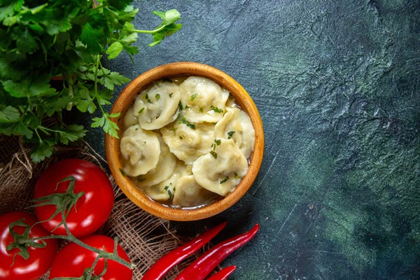 top view yummy meat dumplings with fresh tomatoes greens dark surface - Пельмени с судаком и лососем