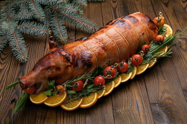 grilled dairy pig on a wooden table christmas dinner - Кесаретский поросёнок
