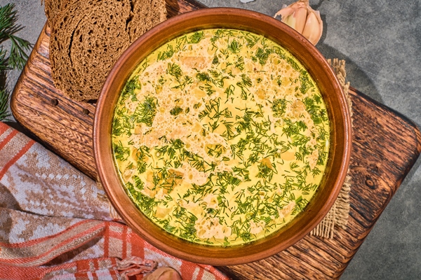 chicken soup with vegetables mushrooms top view close up served with black bread garlic healthy hot winter lunch layout gray background - Чихиртма из курицы (старинный рецепт)