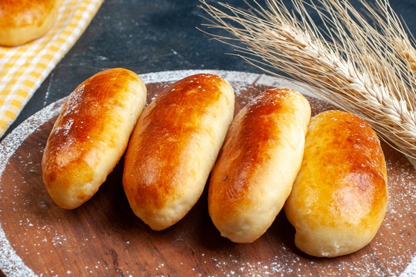 top view potato piroshki kitchen towel wood board wheat table copy space - Пирожки с мясом дрожжевые