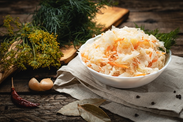 vegan food vegan food sauerkraut with carrots wooden surface eco vegetables with carrots wooden surface - Квашеная капуста с тмином