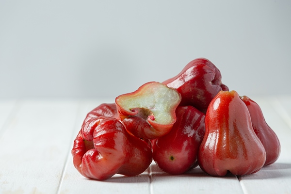 rose apple white wooden surface - Розовое яблоко
