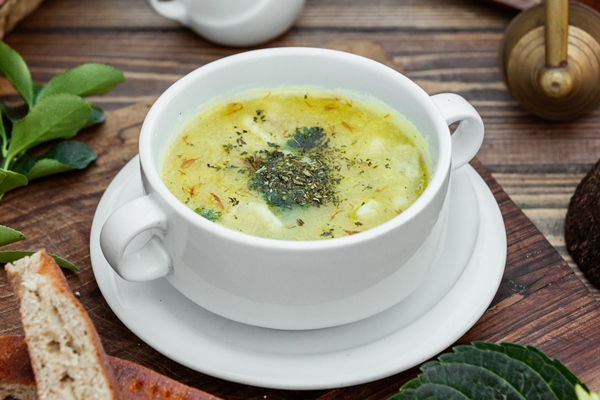 dushbara dumpling soup served with bread wooden table - Овощной суп с миндальным молоком по-французски